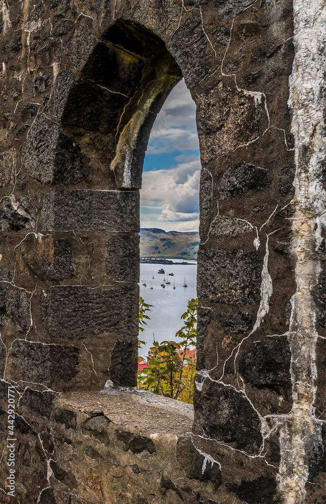 A view of Oban Bay through walls of the tower above the town of Oban, Scotland on a summers day
