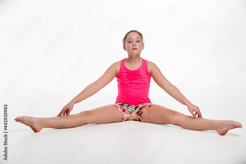A young tween girl streching for a dance routine. A young tween girl streching for a dance routine.