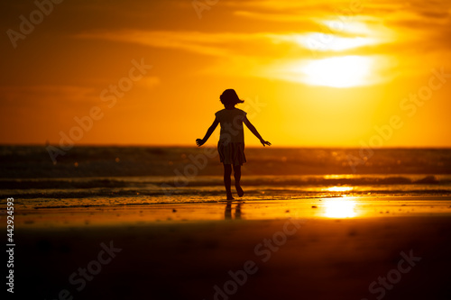 happy young girl on the beach at sunset