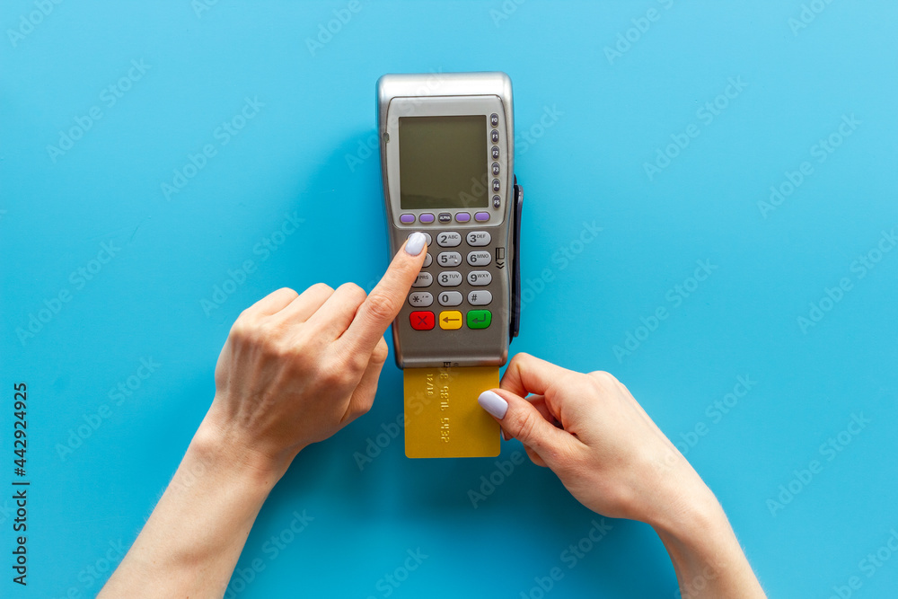 Hand with credit card on pos payment terminal. Top view Hand with credit card on pos payment terminal. Top view