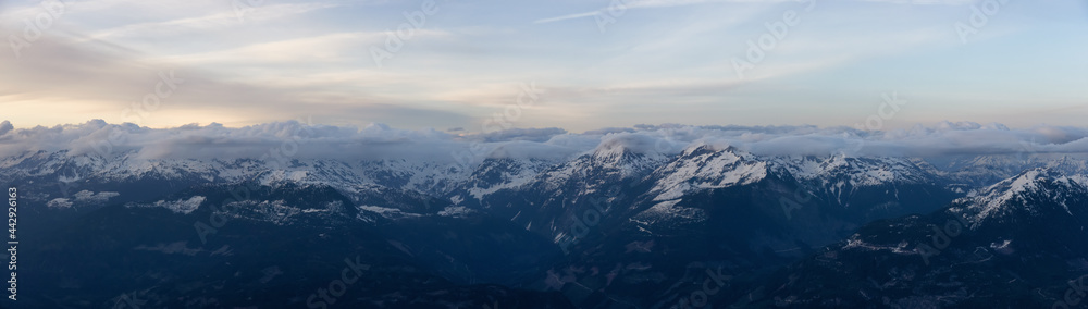Aerial Panoramic View from Airplane of Canadian Mountain Landscape in Spring time. Colorful Sunset. North of Vancouver, British Columbia, Canada. Nature Panorama, Authentic Image