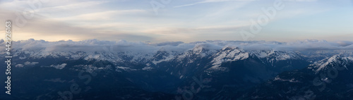 Aerial Panoramic View from Airplane of Canadian Mountain Landscape in Spring time. Colorful Sunset. North of Vancouver, British Columbia, Canada. Nature Panorama, Authentic Image