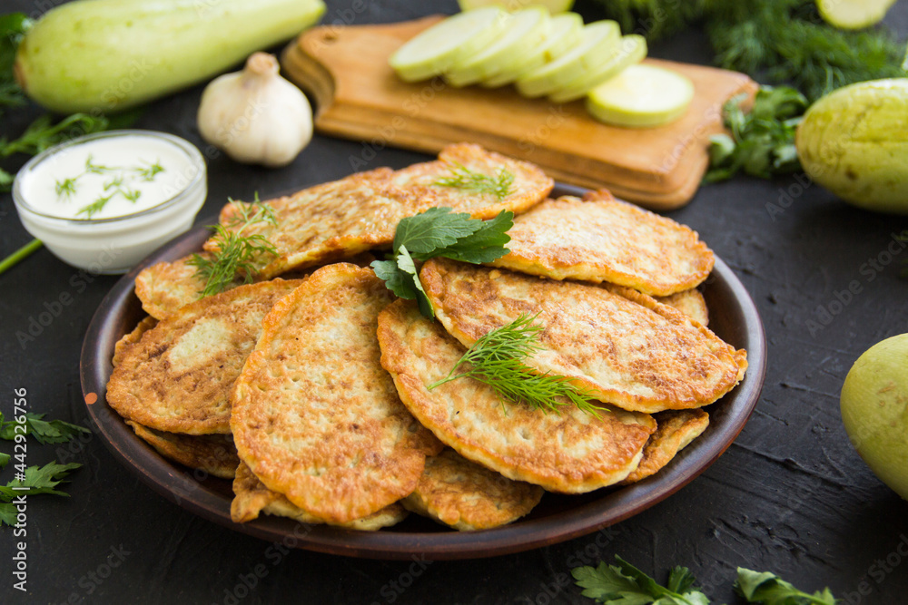 A healthy breakfast of zucchini pancakes. Creative atmospheric decoration A healthy breakfast of zucchini pancakes. Creative atmospheric decoration