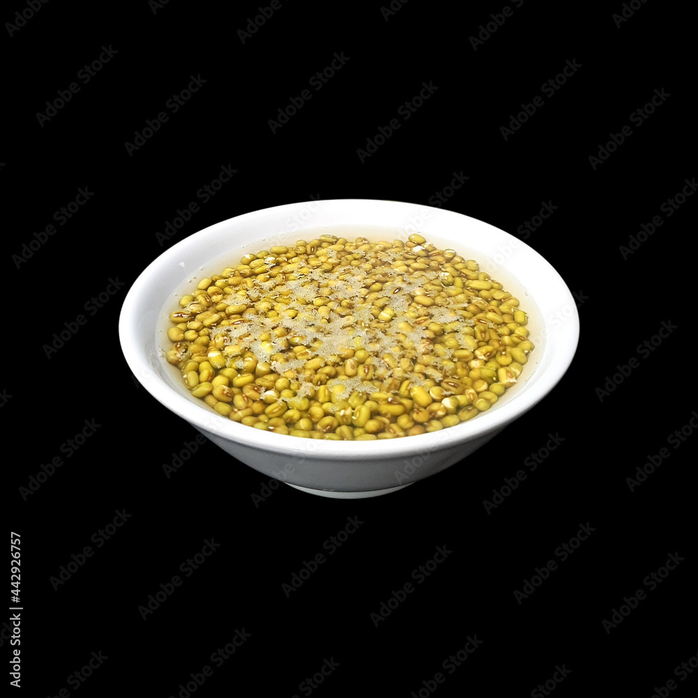 mung beans in a bowl of water isolated on black background mung beans in a bowl of water isolated on black background
