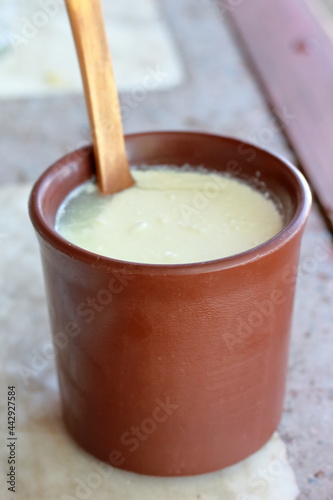closeup of soured milk in brown clay cup
