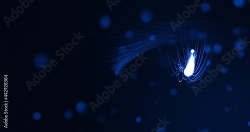 Glowing blue beams of light curving on black background with defocussed blue spots photo