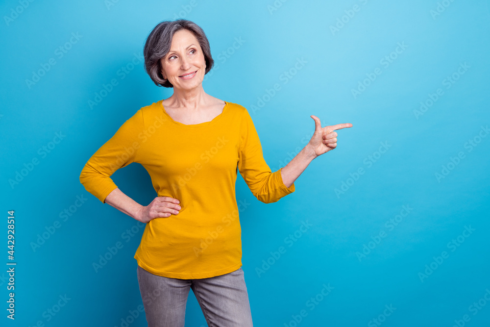 Portrait of attractive curious cheerful woman showing copy space ad advert subscribe isolated over vivid blue color background
