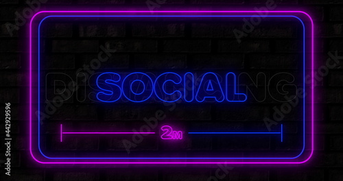 Fototapeta Naklejka Na Ścianę i Meble -  Social distancing neon text against black background