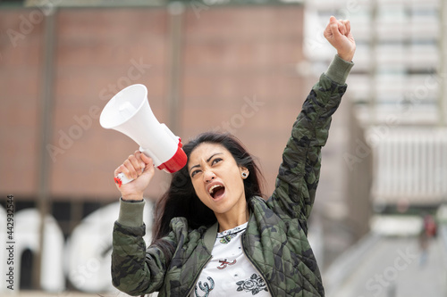Asian rebel with loudspeaker on street