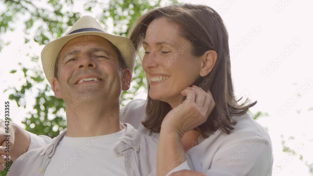POV Profile Shot of Middle Aged Couple Hugging and Laughing into the Camera