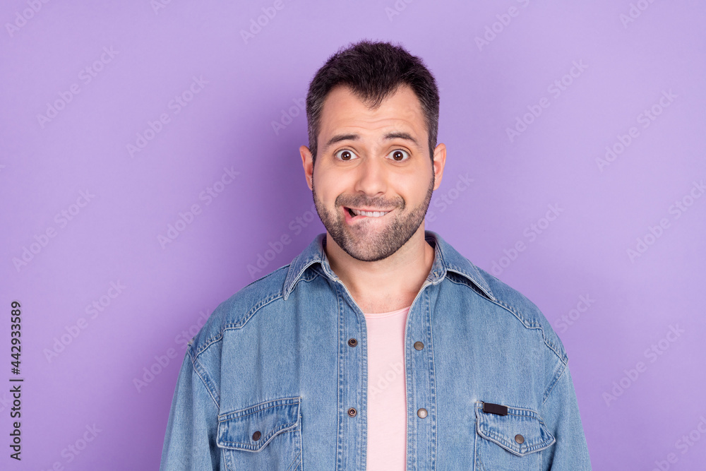 Photo portrait brunet man in casual outfit biting lip stressed isolated pastel purple color background
