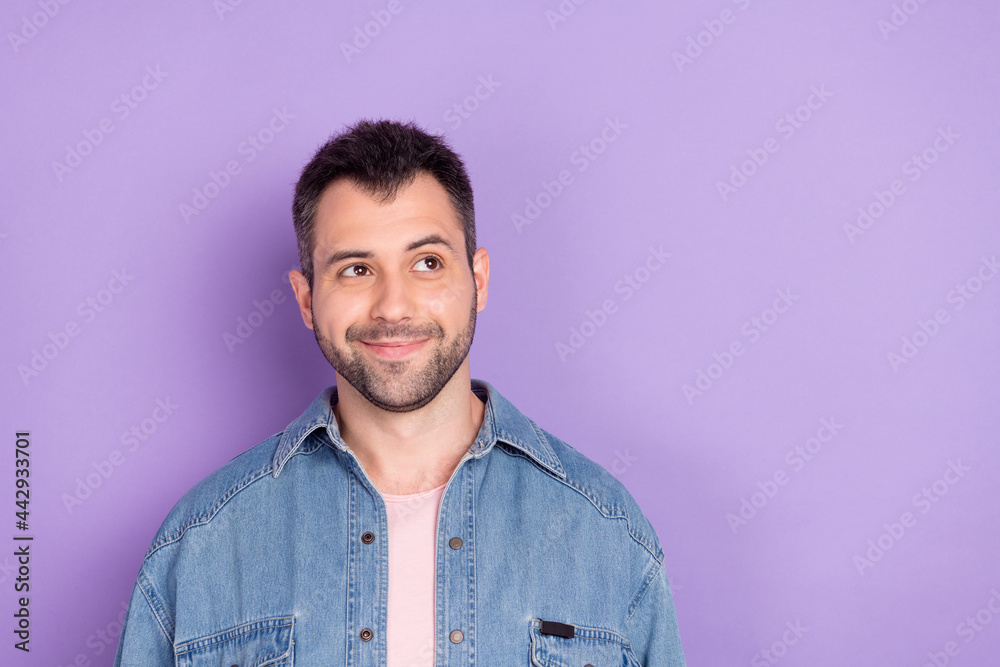 Photo of young handsome man happy positive smile think dream look empty space isolated over violet color background
