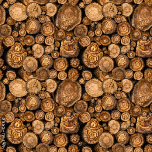 Sawn tree trunks stacked in a woodpile. Seamless pattern