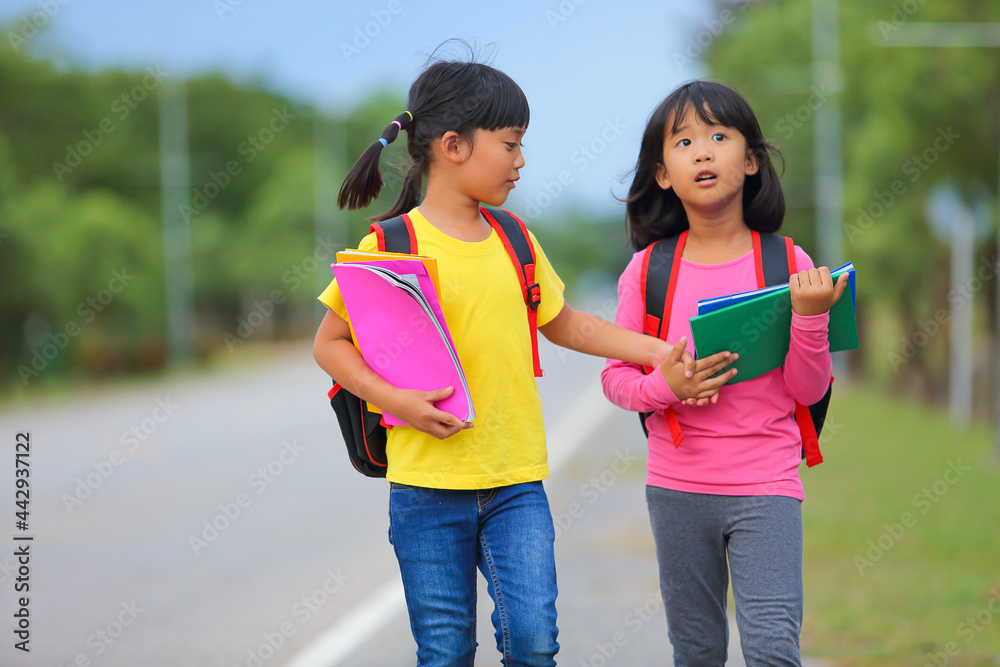 Back to school after covid-19 epidemic.Two cute little girl walking and ...