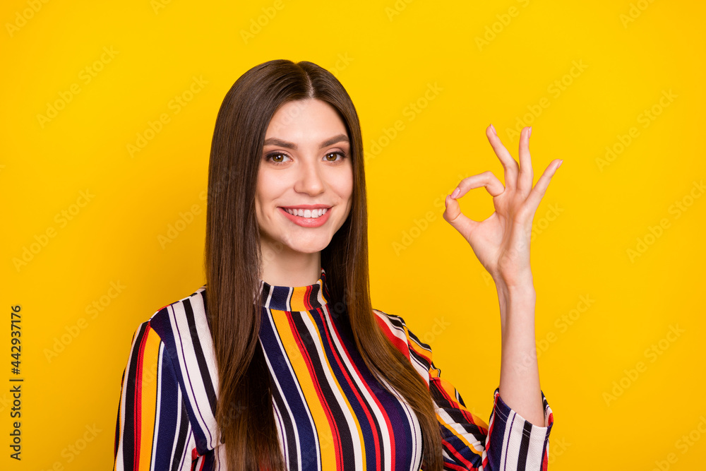 Photo of young attractive woman happy positive smile show okay alright perfect ad sign isolated over yellow color background Photo of young attractive woman happy positive smile show okay alright perfect ad sign isolated over yellow color background