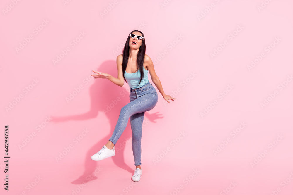 Full length body size photo woman in sunglass dancing at party isolated pastel pink color background