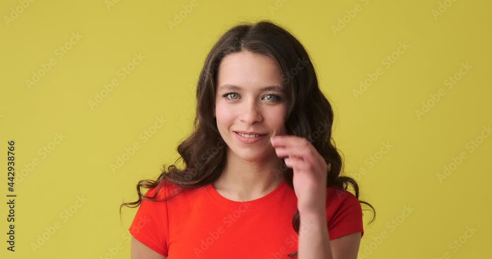 Beautiful woman smiling over yellow background Beautiful woman smiling over yellow background