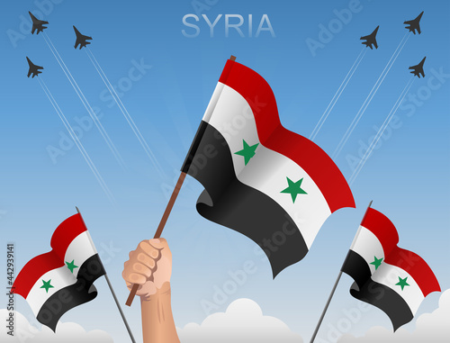 Syrian flags flying under the blue sky 