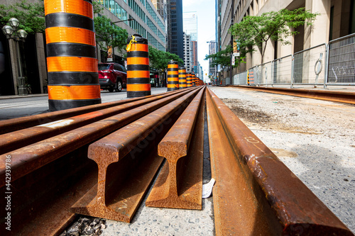 Photography Rails wait to be laid into the street car track system on a downtown street in T