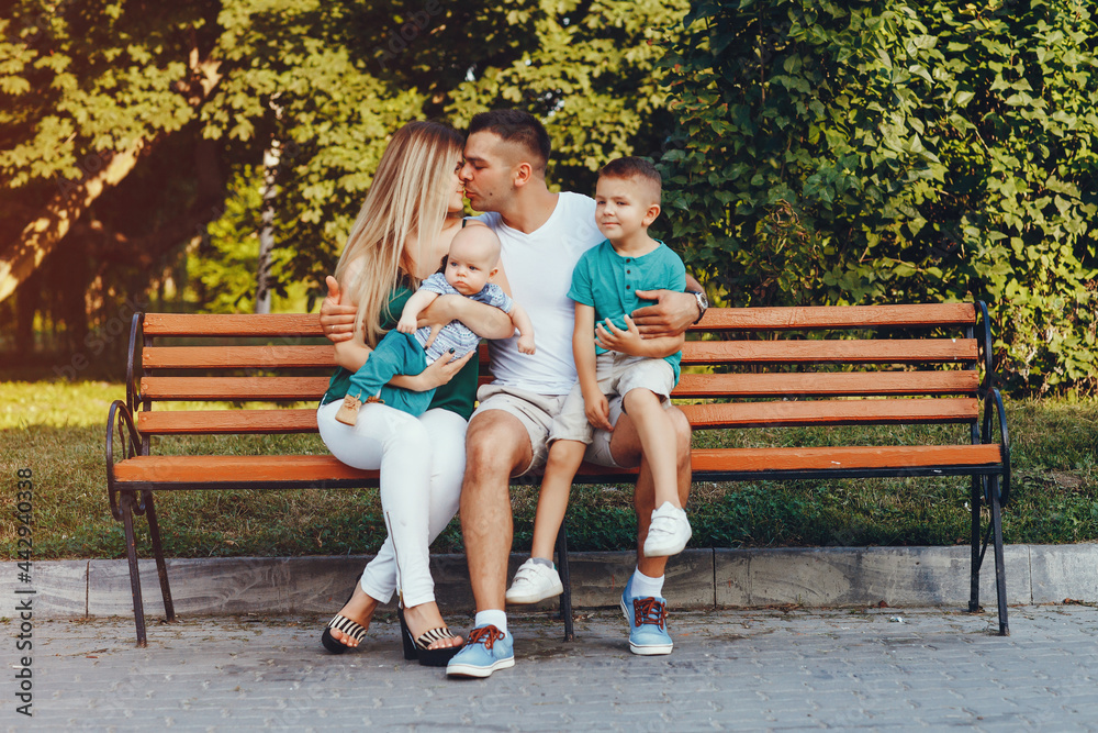 Cute family playing in a summer park Cute family playing in a summer park