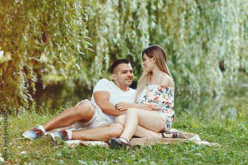 Beautiful couple spend time on a summer field © hetmanstock2
