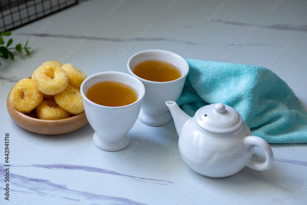 White ceramic tea set with donuts