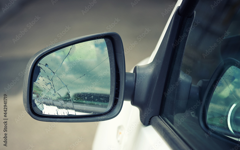 Broken car wing mirror. Damaged car side mirror, cracked glass. Bad driving, problems with car. Road accident concept