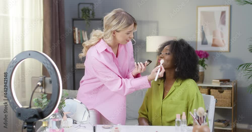 Young Caucasian modern beauty blogger starting makeup tutorial video shooting on cellphone making video for vlog. Makeup artist recording video tutorial doing make up Beauty blogger fashion influencer