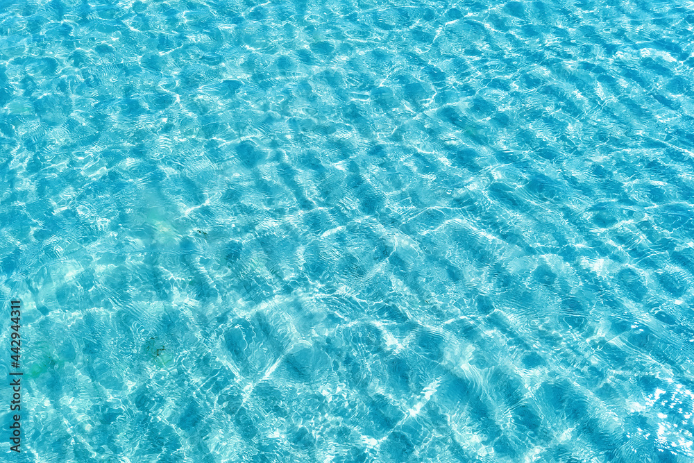 Obraz premium Background shot of aqua water surface. Swimming pool with sunny reflections.