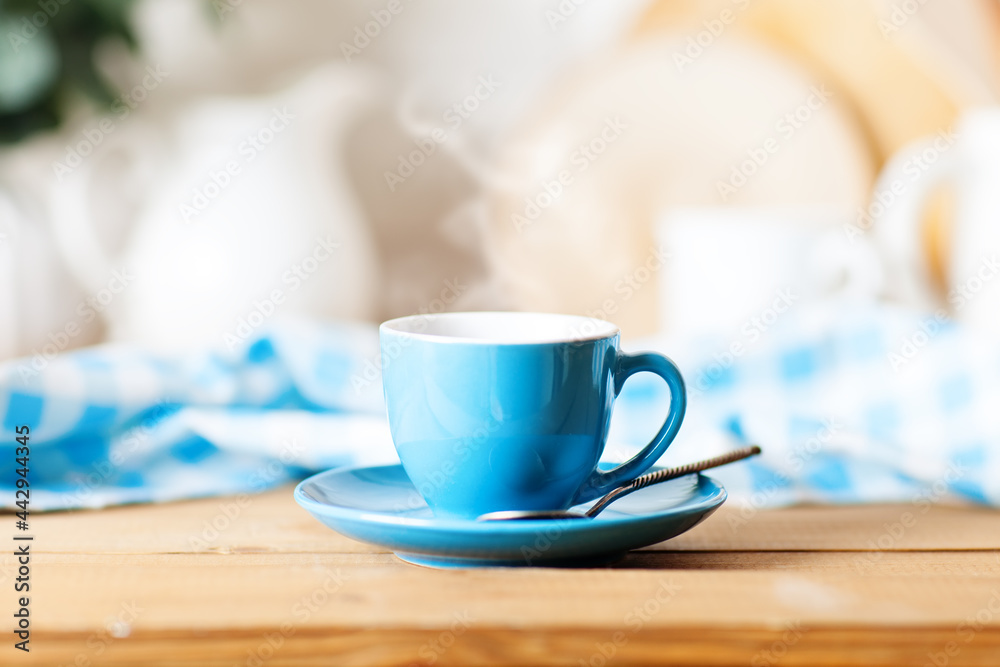 Obraz premium A clean blue cup in the kitchen. Mockup. Selective focus. Mock-up of a tea mug.