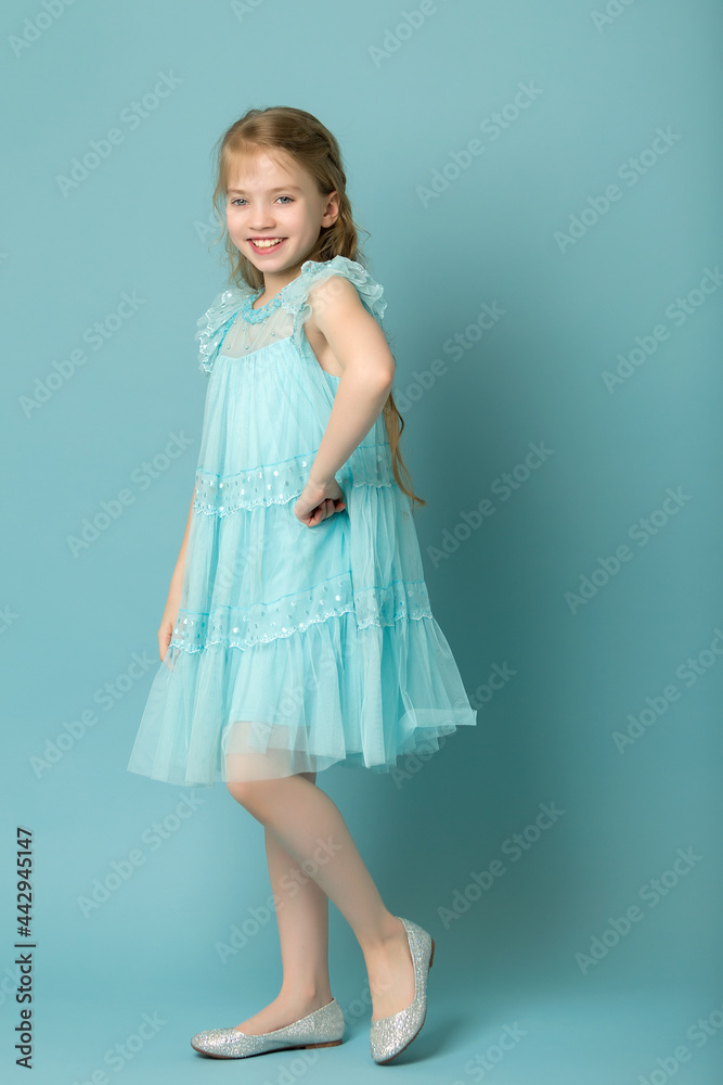 Little girl in an elegant dress.The concept of a happy childhood Little girl in an elegant dress.The concept of a happy childhood