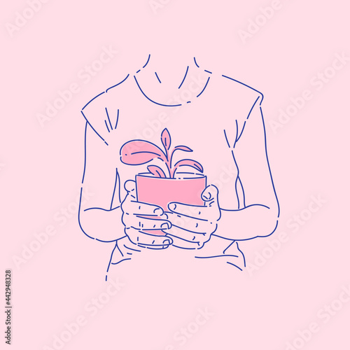 A young girl holds a flower pot in her hands. A woman takes care of plants. Hands carefully hold a home flower.