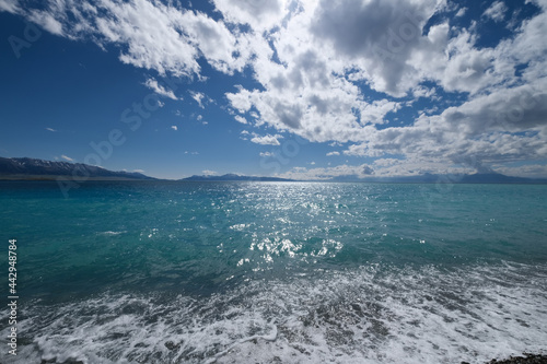 wide beautiful blue rushing sea water under sunshine. At Sayram Lake. Travel destination of Xinjiang China