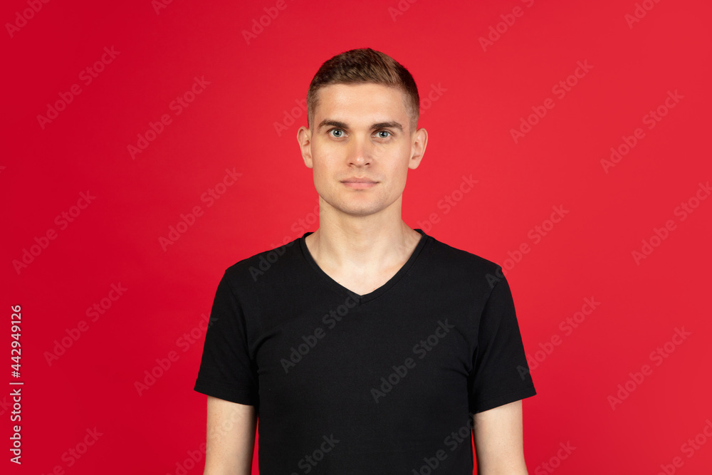 Caucasian man's portrait isolated over red studio background with copyspace for ad. Concept of human emotions Caucasian man's portrait isolated over red studio background with copyspace for ad. Concept of human emotions