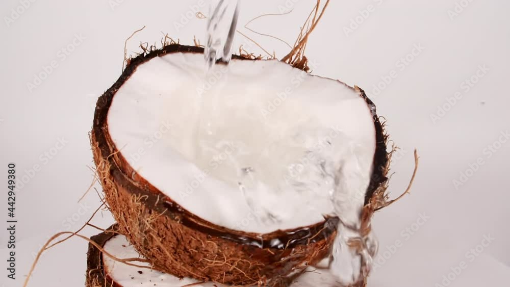 Slow Motion Dripping Coconut Milk and Juice, Splashing of Coco nuts Oil over. Healthy Food. Macro Shot. High quality FullHD footage
