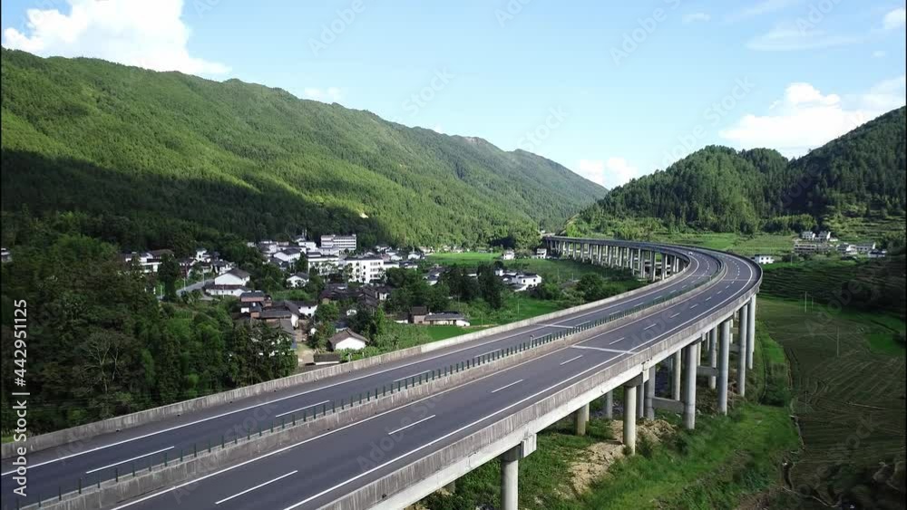 Aerial view of a two-lane highway that runs through the mountains Aerial view of a two-lane highway that runs through the mountains