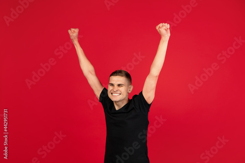 Caucasian man's portrait isolated over red studio background with copyspace for ad. Concept of human emotions