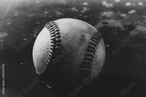 Old grunge baseball texture in black and white closeup of old ball.