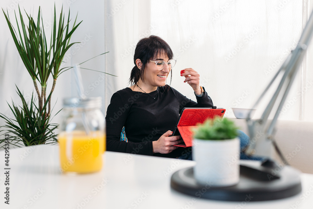 Content woman watching video on tablet at home Content woman watching video on tablet at home