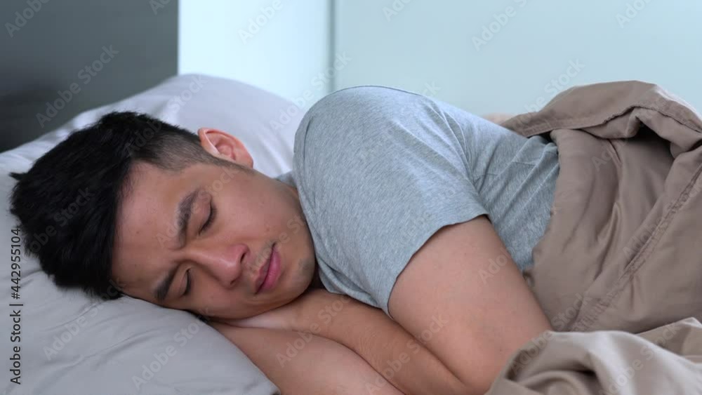 Depressed young Asian man cannot sleep from insomnia. Depressed man suffering from insomnia. Depressed young Asian man cannot sleep from insomnia. Depressed man suffering from insomnia.