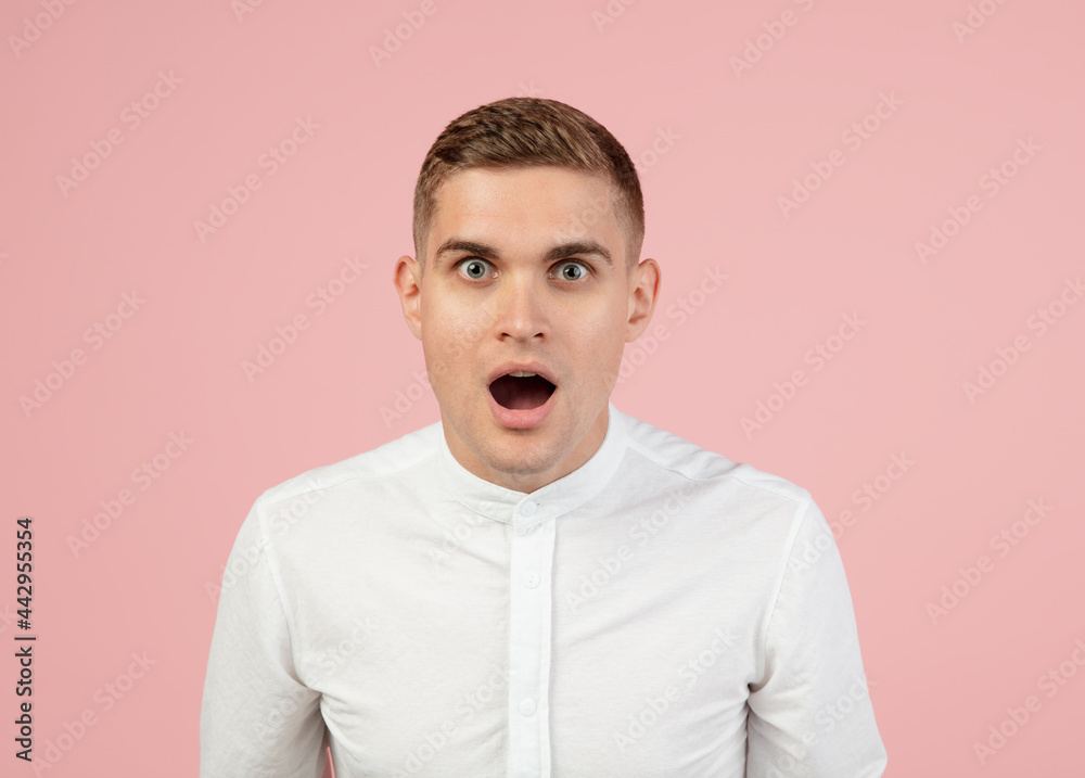 Portrait of young Caucasian man posing isolated over pink studio background with copyspace for ad. Concept of human emotions Portrait of young Caucasian man posing isolated over pink studio background with copyspace for ad. Concept of human emotions