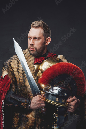 Legionnaire in fur and golden armor with gladius