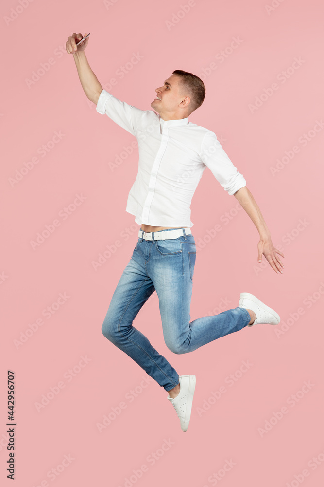 Portrait of young Caucasian man posing isolated over pink studio background with copyspace for ad. Concept of human emotions Portrait of young Caucasian man posing isolated over pink studio background with copyspace for ad. Concept of human emotions