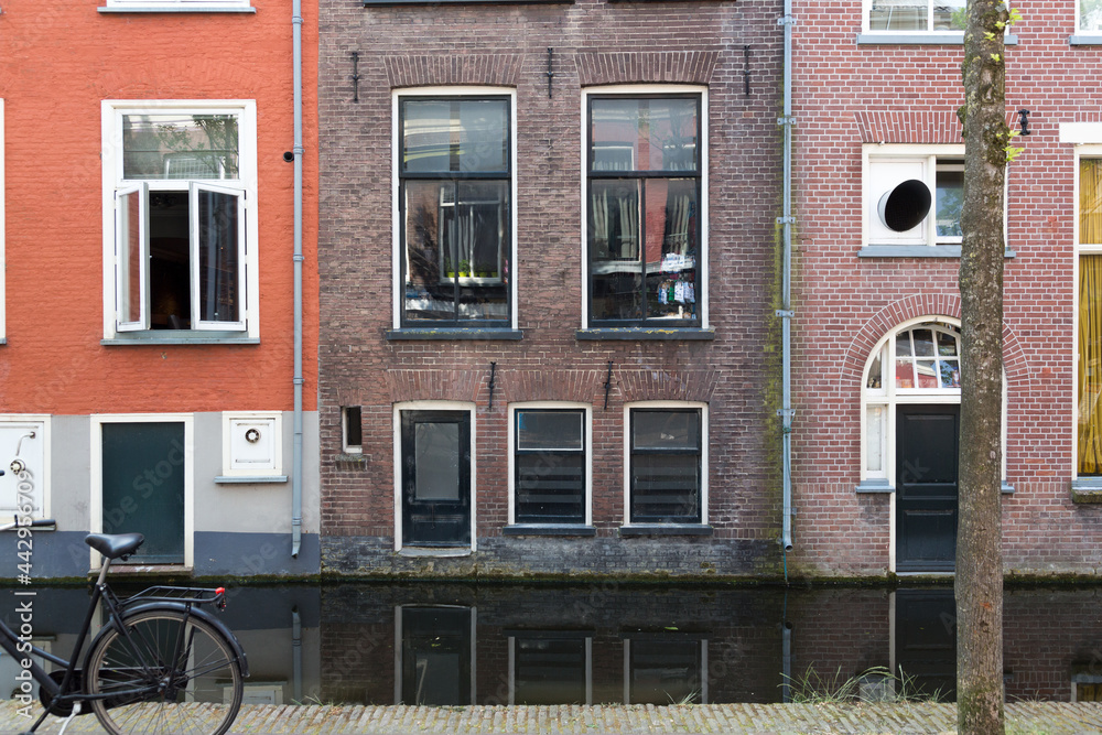 Authentic colorful brick house fronts - facades in the historical center of  Delft, The Netherlands