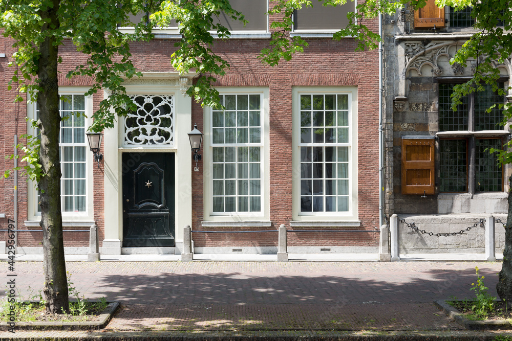 Authentic colorful brick house fronts - facades in the historical center of Delft, The Netherlands Authentic colorful brick house fronts - facades in the historical center of Delft, The Netherlands