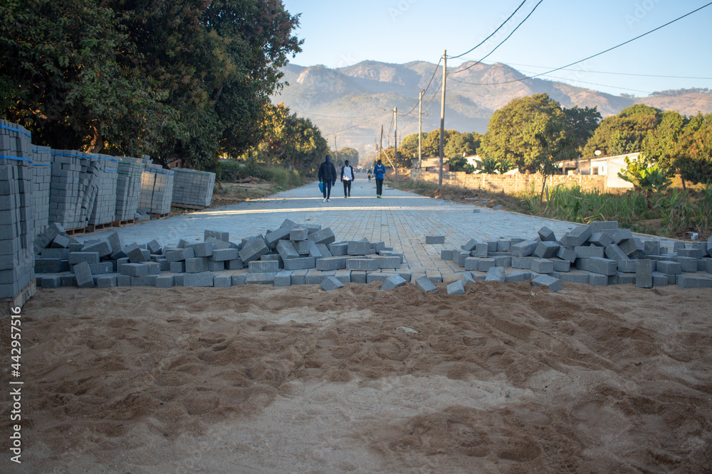 Concrete pavers being used to replace a dirt road