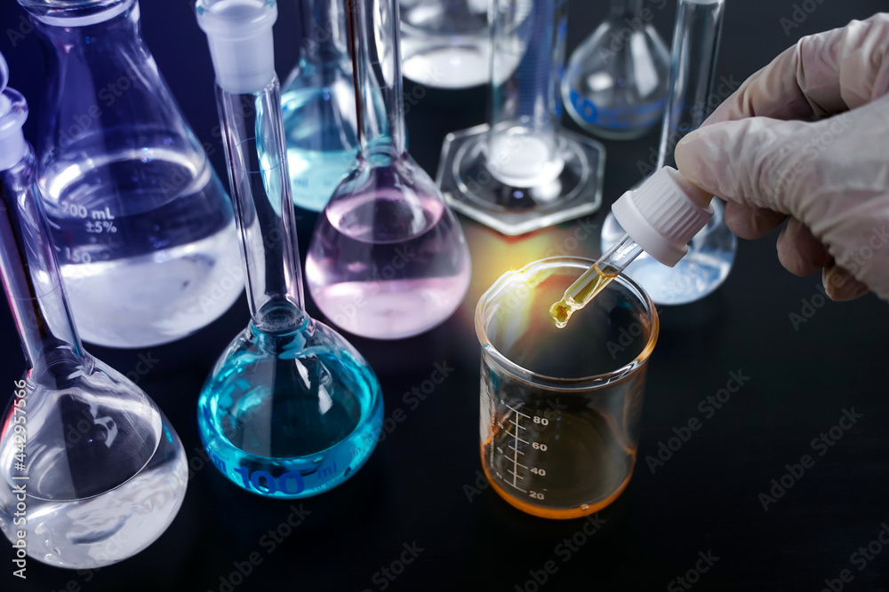 Scientist or medical in lab coat holding test tube with using reagent ...