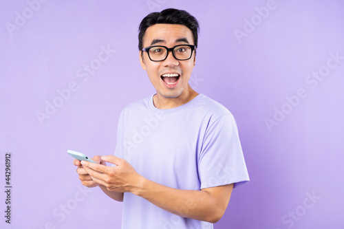 Asian man portrait, posing on purple background © 1112000