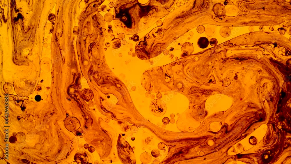 Colorful oil drops floating on water surface, top view. Fantastic abstract background. Bright bubbles moving and spreading. Close up 4k video of weird liquid structures. Scientific chemical experiment