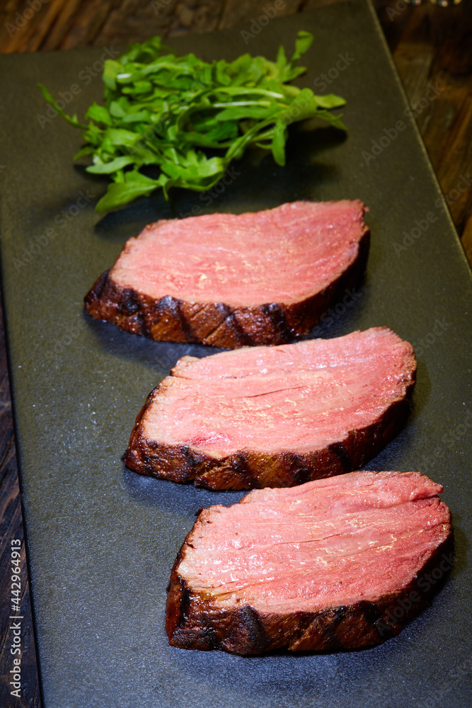 Sousvide steak cut into pieces, cooked to eat beef on the stone table Stock Photo Adobe Stock
